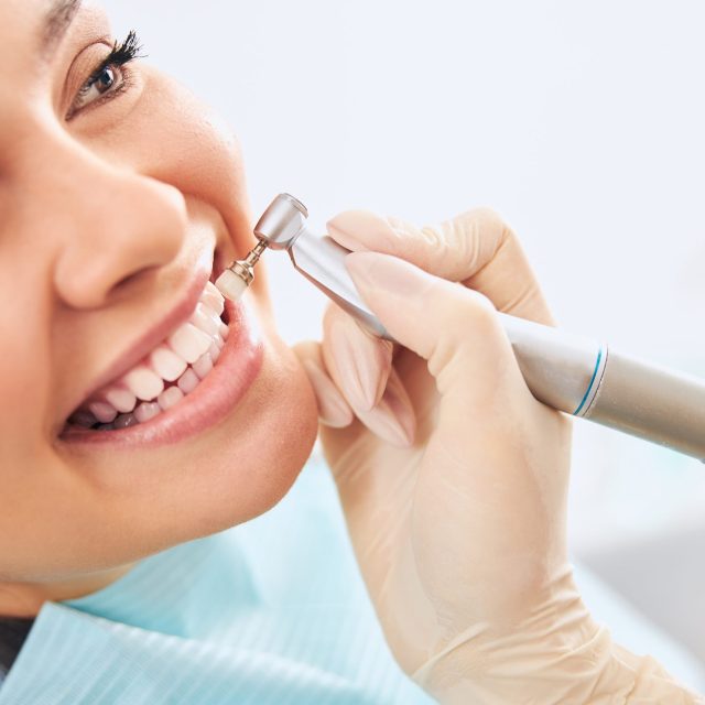 Cheerful female person demonstrating her smile while doing dental care interaction