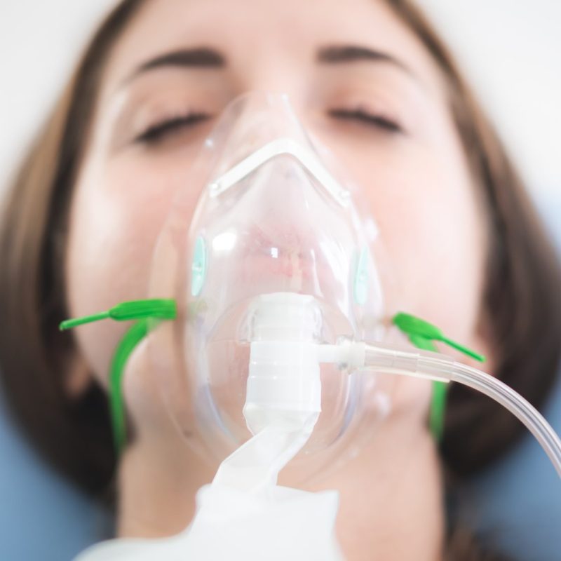 woman patient wearing oxygen mask sleeping on hospital bed, Pre